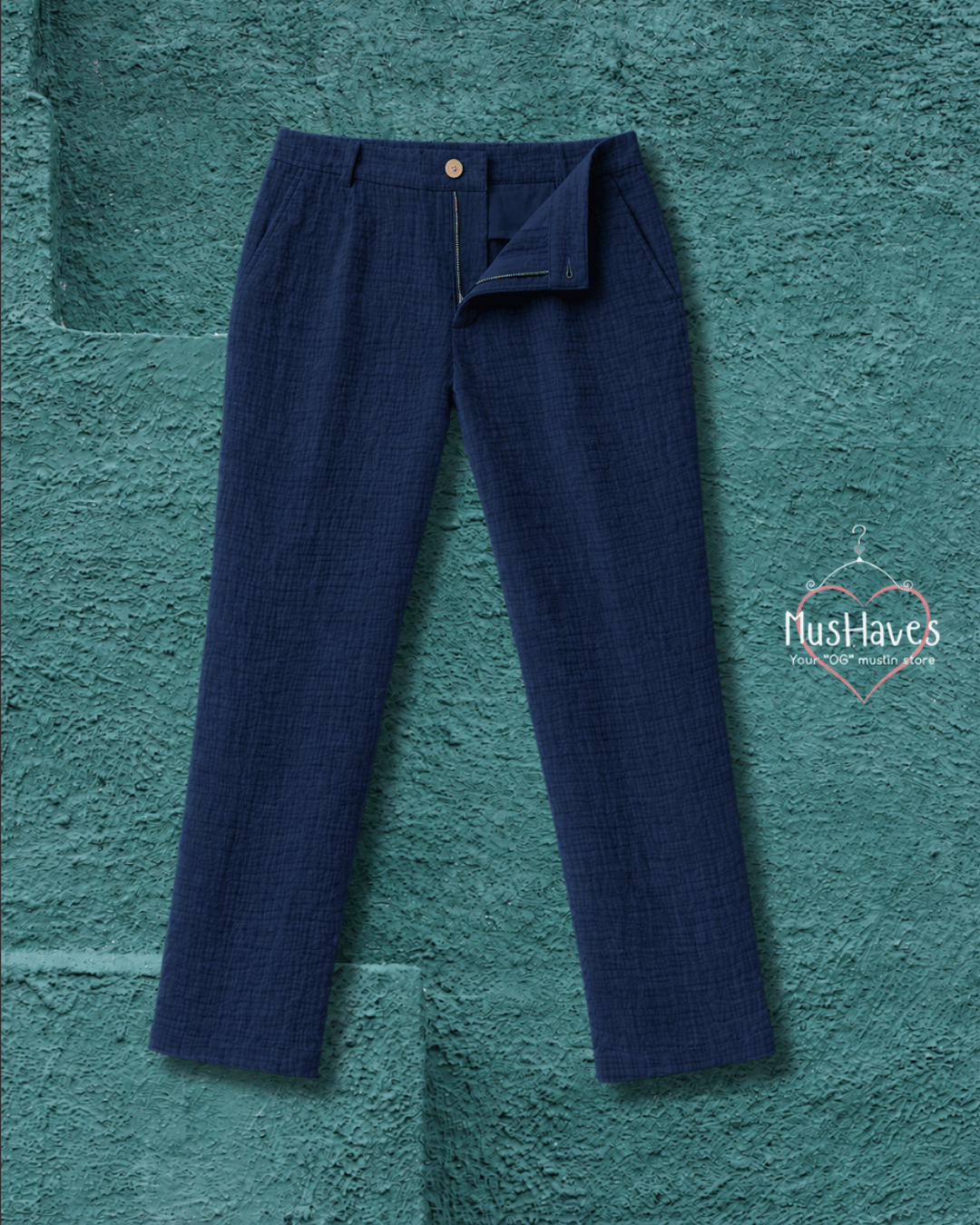 Navy blue pants on a textured teal background with 'MushHaves' logo.
